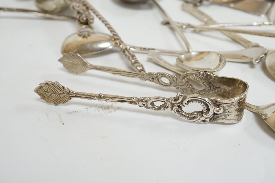 A group of assorted silver and white metal tea and coffee spoons and a pair of silver sugar tongs, weighable hallmarked silver 8.6oz.